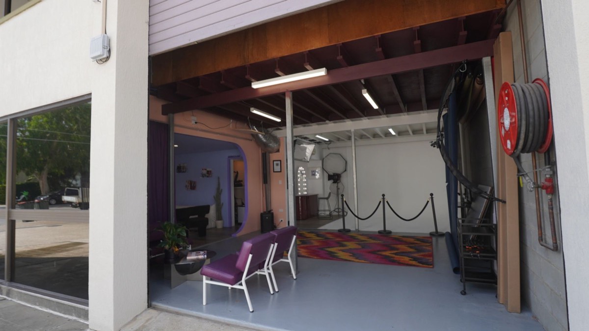 The roller door open at street level, giving step-free access into the studio